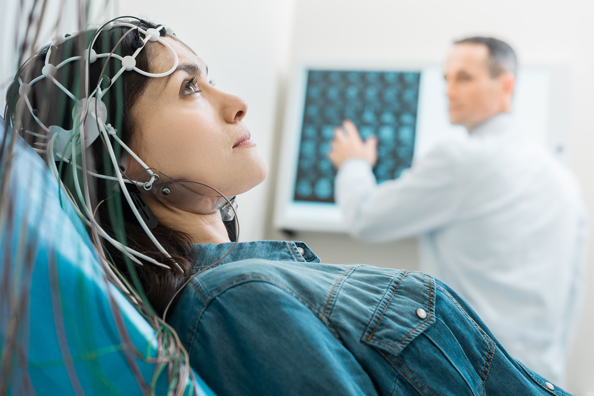 Patient wearing an EEG sensor cap during a brain-wave recording